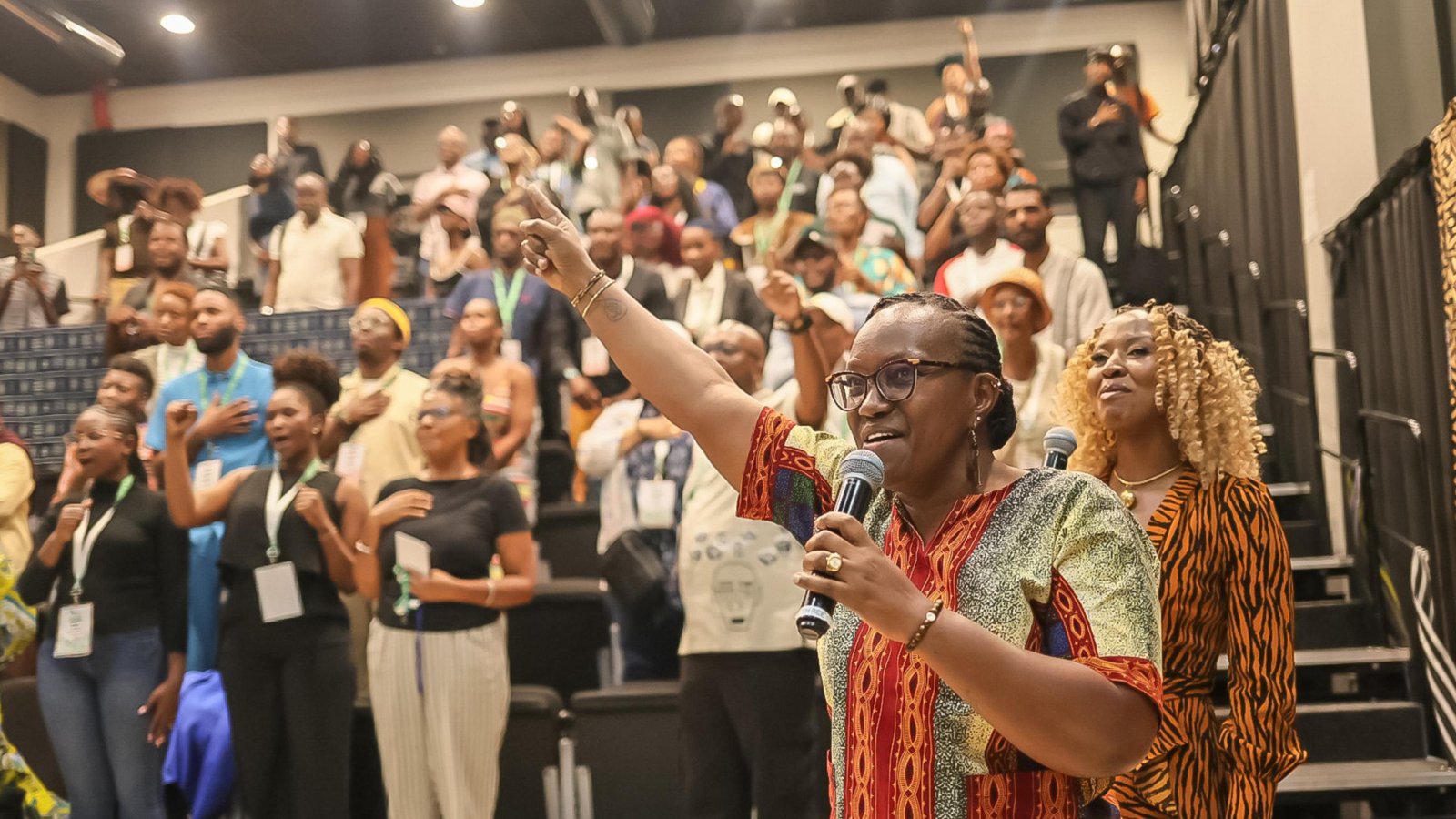 A delegate speaks to a cheering audience at the Afrotellers Conference 2025